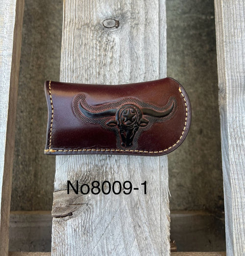 A Coffee Brown leather knife sheath with a embossed Longhorn and Star design. Front View